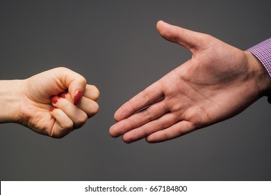 Illustration of a wrong way to shake hands - one person reaches out open hand, while other offers closed fist for fistbump