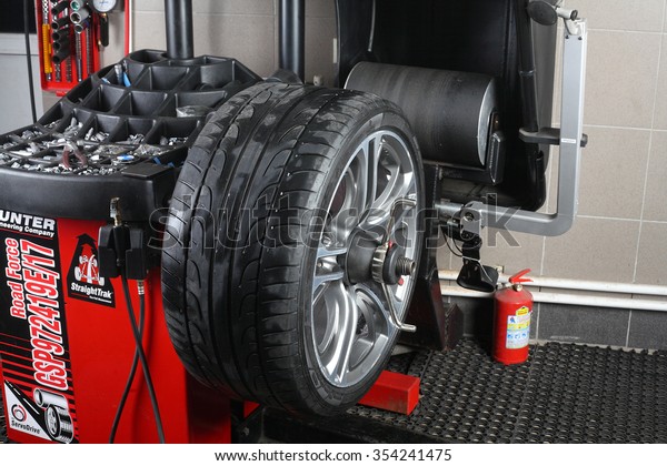 Illustrative editorial. Balancing tire wheel\
machine Hunter.  Tyre assembling. Tire balance. Car service\
\