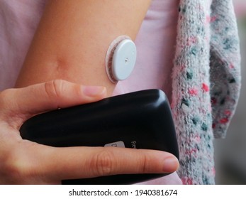 Illustrative editorial image -  activation and reading of sensor for continuous glucose monitoring – CGM, producer Abbott,  device Freestyle Libre 2. Serbia, March 2021. Diabetes type 1. 