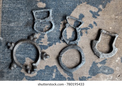 ILLUSTRATIVE EDITORIAL.Small Bronze Items 10-12 C.(found With Metal Detector Near Kiev).Background - Russian School Textbook Geography Of Europe Circa 1910.
Kiev,Ukraine December 22 ,2017