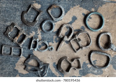 ILLUSTRATIVE EDITORIAL.Small Bronze Items 10-12 C.(found With Metal Detector Near Kiev).Background - Russian School Textbook Geography Of Europe Circa 1910.
Kiev,Ukraine December 22 ,2017