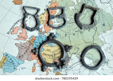 ILLUSTRATIVE EDITORIAL.Small Bronze Items 10-12 C.(found With Metal Detector Near Kiev).Background - Russian School Textbook Geography Of Europe Circa 1910.
Kiev,Ukraine December 22 ,2017