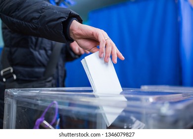 Illustrative Image Of The Election In A Democratic Society. Elections In Ukraine. The Process Of Voting At A Polling Station. The Voter Throws The Ballots In The Ballot Box.