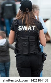 Illzach - France -9 June 2019 - Portrait Of Woman With Swat Police Uniform Walking On Back View  At Fun Car Show Event