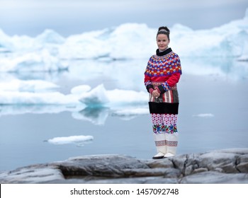 Ilulissat, Greenland - Jul 31, 2018: Young Inuit Woman In Traditional Clothing Posing For Photos In A Small Greenlandish Village.