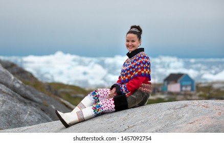 Ilulissat, Greenland - Jul 31, 2018: Young Inuit Woman In Traditional Clothing Posing For Photos In A Small Greenlandish Village.