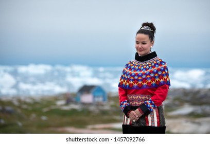 Ilulissat, Greenland - Jul 31, 2018: Young Inuit Woman In Traditional Clothing Posing For Photos In A Small Greenlandish Village.