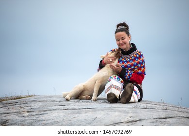 Ilulissat, Greenland - Jul 31, 2018: Young Inuit Woman In Traditional Clothing Posing For Photos In A Small Greenlandish Village.