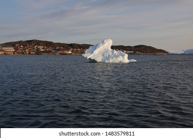 Ilulissat, Greenland - July 31, 2019: An Iceberg Grounds Near The Harbor. The Greenland Ice Sheet Is Experiencing Record Melt And The U.S. President Has Expressed Interest In Buying Greenland