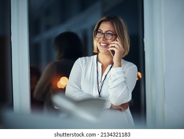 Im Coming Home. Shot Of A Businesswoman Talking On A Mobile Phone During A Late Night At Work.