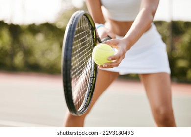 Im focused on the ball. an unrecognisable tennis player standing on the court and getting ready to serve during practice. - Powered by Shutterstock