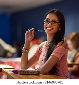 Im Going To Ace My Exams. Portrait Of A Beautiful University Student Making Notes While Sitting In A Lecture Hall.