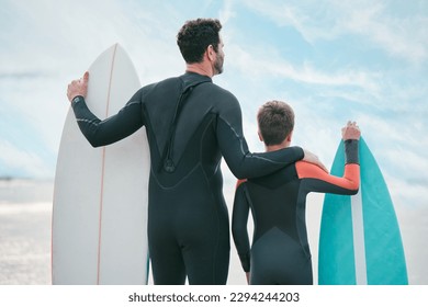 Im going to teach you how to catch a wave, son. Shot of a man and his young son at the beach with their surfboards. - Powered by Shutterstock