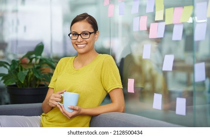 Im Having A Sneaky Second Cup. Attractive Female Office Worker Sneaking In A Second Cup Of Coffee On Her Break.