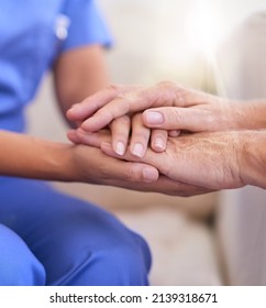 Im Here To Help. Cropped Shot Of A Nurse Holding A Senior Womans Hands In Comfort.