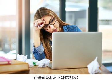 Im Just Not Getting This. Shot Of A Female University Student Looking Stressed While Sitting At A Table On Campus Using A Laptop.