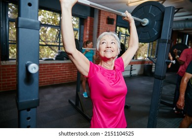 Im Like Nothing Youve Ever Seen Before. Shot Of A Senior Woman Lifting Weights At The Gym.