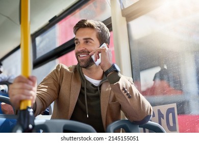 Im On The Bus. Cropped Shot Of A Handsome Young Man Making A Phonecall During His Morning Bus Commute.