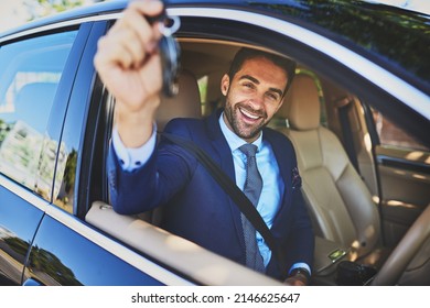 Im On My Way To An Important Meeting. Portrait Of A Cheerful Young Businessman Holding Up Keys To The Camera While Being Seated In His Car.