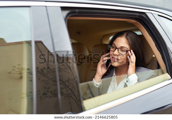 Im on my way to a meeting, see you\
later. Shot of a young businesswoman talking on her cellphone while\
sitting in the backseat of a\
car.