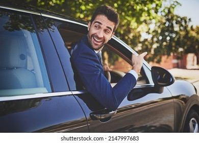 Im On My Way To Work Buddy. Shot Of A Cheerful Young Businessman Hanging Out Of A Car Window And Pointing With His Hand Towards The Front Of His Car.