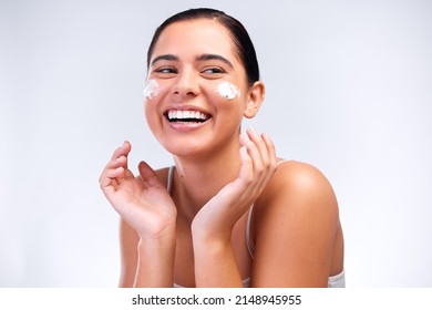 Im Picky With Two Things, My Friends And What I Put On My Skin. Shot Of A Beautiful Young Woman Applying Moisturiser To Her Face.