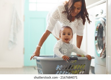 Im The Pirate Of This Ship. Shot Of A Mother And Her Adorable Baby Boy Doing The Laundry At Home.