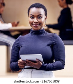 Im ready to lead this business. Shot of an attractive young businesswoman standing in the office and holding a digital tablet.