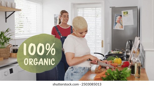 Image of 100 percent organic text over diverse female couple cooking at home. Lifestyle, ecology and digital interface concept digitally generated image. - Powered by Shutterstock