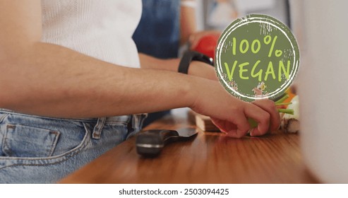 Image of 100 percent vegan text over diverse female couple cooking at home. Lifestyle, ecology and digital interface concept digitally generated image. - Powered by Shutterstock