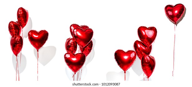 Set of Air Balloons. Bunch of red color heart shaped foil balloons isolated on white background. Love. Holiday celebration. Valentine's Day party decoration. Metallic red colour Heart air ballons