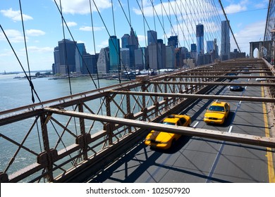 New York Manhattan skyline from the Brooklyn Bridge with yellow taxi's