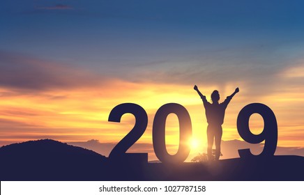 Silhouette freedom young woman Enjoying on the hill and 2019 years while celebrating new year, copy spce.