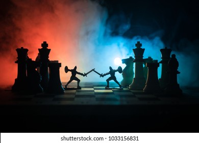 Medieval battle scene with cavalry and infantry on chessboard. Chess board game concept of business ideas and competition and strategy ideas Chess figures on a dark background with smoke and fog.