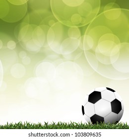 カラフルな背景を持つ緑の芝生でサッカー