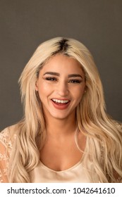 Beautiful blonde woman portrait smiling while looking at camera