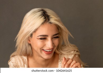 Gorgeous blonde woman portrait laughing and wearing lace dress