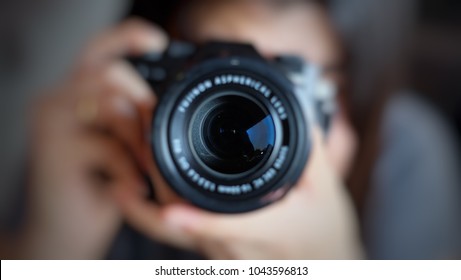 Soft focus of women photographer hold camera and taking a photo. 