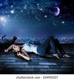 a girl and a cat are lying on a rooftop under the starry sky
