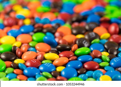 Colorful chocolate M&Ms in and out of focus