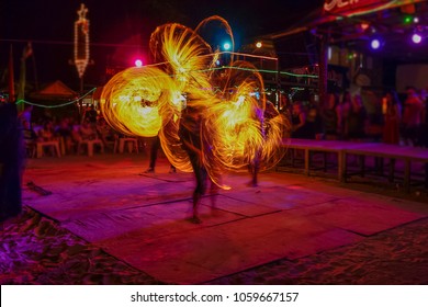 Fantastic Fire Show on the beach with colorful of fire moving, full moon party night life on the beach, Phi Phi island, Krabi, Thailand.