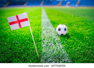 England national Flag and football ball on green grass. Fans, support photo, edit space.