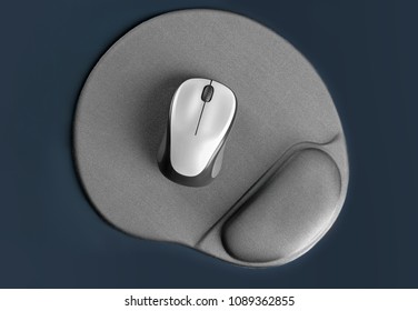Blank pad and wireless computer mouse on grey background, top view