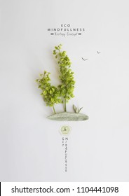 Environmentally friendly planet. Green trees on the planet, made of green grass and  leaves, isolated on bright background. Minimal nature concept. Think Green. Ecology Concept. Flat lay. Top view.