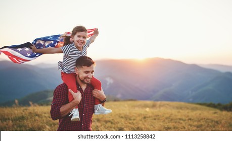 ayah dan anak keluarga yang bahagia dengan bendera amerika serikat menikmati matahari terbenam di alam