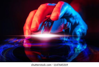 Close up of Hand over wireless Game Mouse on dark background ; The finger ready to click