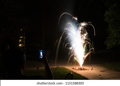 Ground spark shower fireworks or firecrackers in home driveway at night