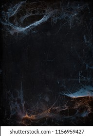 Halloween background with copyspace. Old terrible cobweb in darkness 
