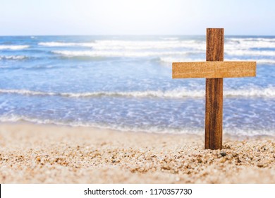 cruz de madera en la playa con fondo marino borroso, el concepto cristiano muestra el amor de Dios ancho y profundo como el mar