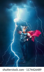 little boy in thor costume with lightnings and thunder epic